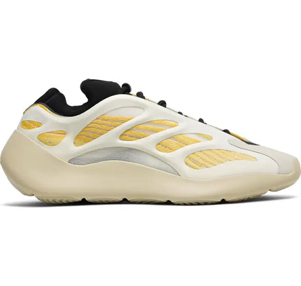 Athletic sneaker in cream and gold with wavy pattern from Adidas Yeezy 700 V3 Safflower