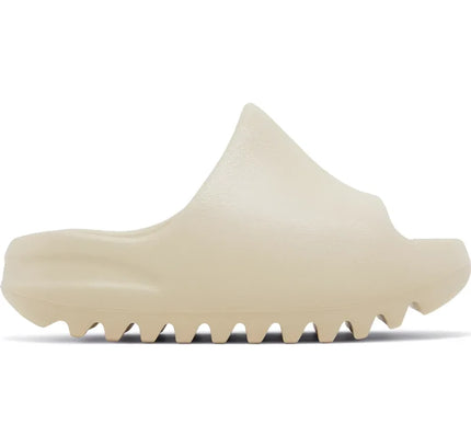 Cream-colored adidas Yeezy Slide Bone for kids featuring a ridged sole design