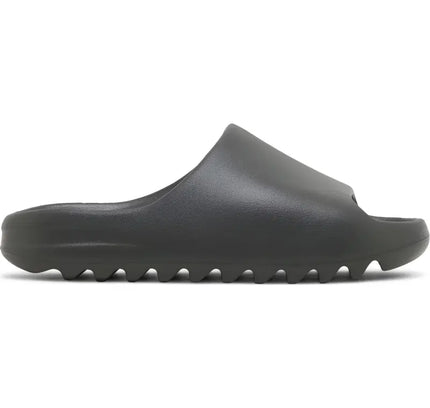 Black rubber adidas Yeezy Slide Dark Onyx with ridged sole in stealthy charcoal hue