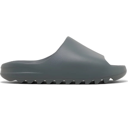 Dark gray Adidas Yeezy Slide Slate Marine with textured rubber sole for comfort