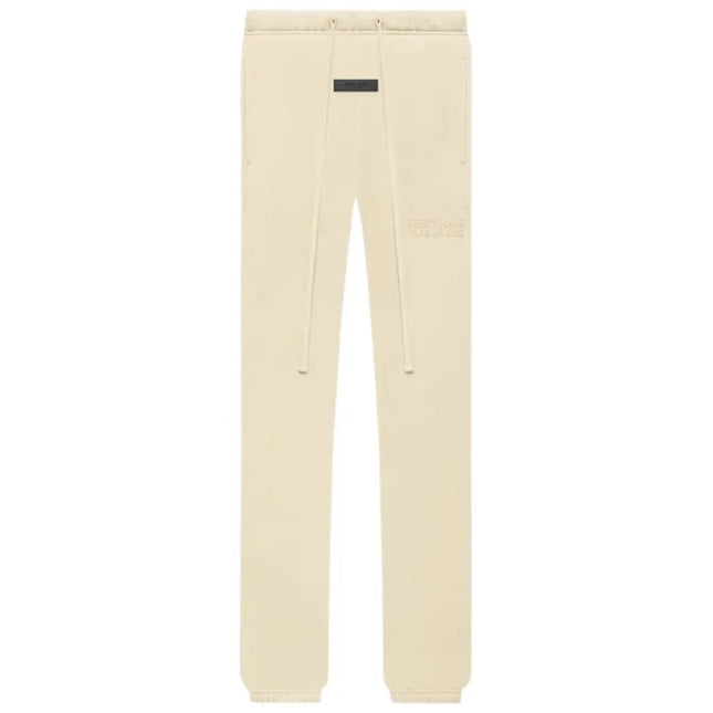 Cream-colored Fear of God Essentials Classic Sweatpant Shell with black brand tag