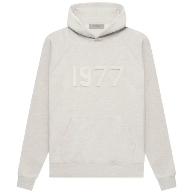 Light gray Fear of God Essentials Hoodie with embossed 1977 text on front