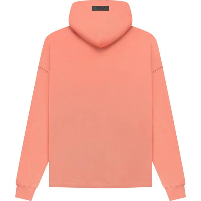 Peach-colored Fear of God Essentials Relaxed Hoodie with ribbed cuffs and long sleeves