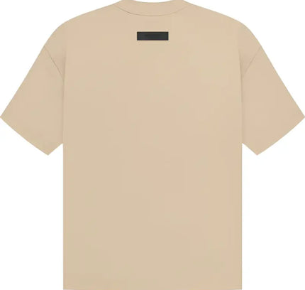 Beige Fear of God Essentials SS Tee featuring a small black rectangle tag on the back