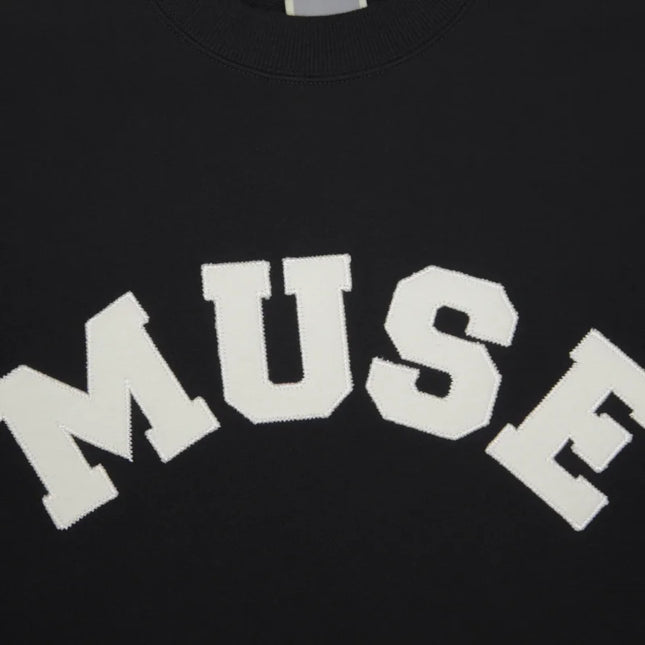 White text spelling MUSE on a French Terry Sweatshirt made of soft cotton fabric