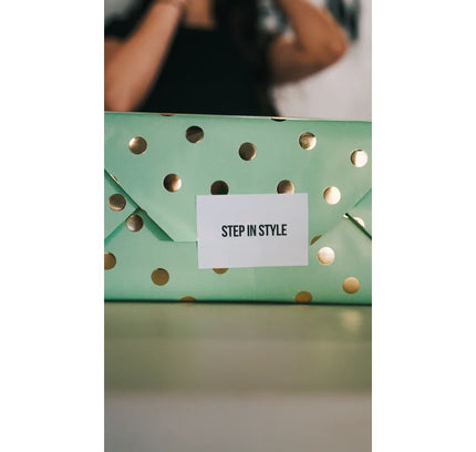 Mint green polka-dotted gift box with STEP IN STYLE label perfect for gift wrapping