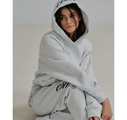 Woman in gray hoodie and sweatpants featuring Heavyweight Joggers, perfect blend of comfort