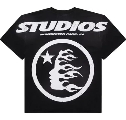 Black T-shirt with white STUDIOS text and circular flame logo from Hellstar Studios Cartoon