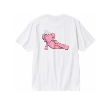 White T-shirt featuring a pink cartoon elephant design, KAWS x Uniqlo sleeve graphic pink