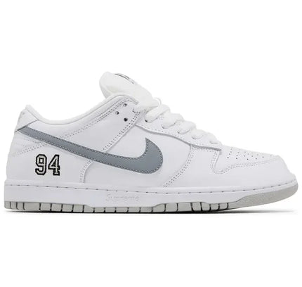 White Nike SB Dunk Low Supreme sneakers with gray accents and 94 on the heel in white metallic silver