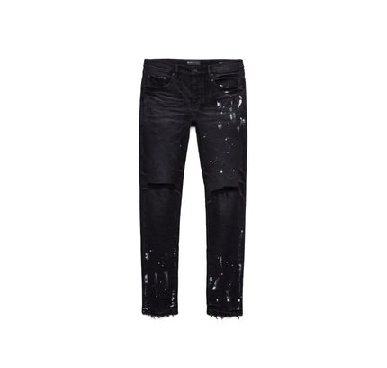 Distressed black jeans with paint splatters and signature hang tag in P001 Black Resin Knee Slit style