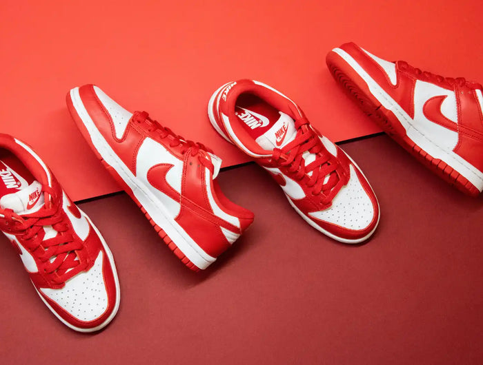 Red and white Nike sneakers arranged in a row.